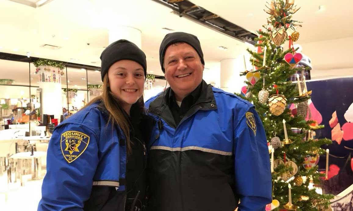 male and female security officers in blue coats