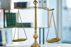 gold justice scales on desk