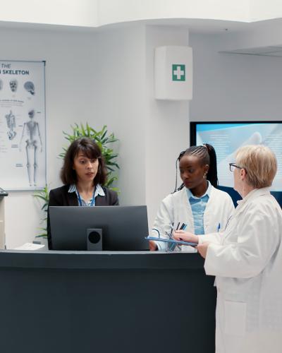 physician talking patient at front desk